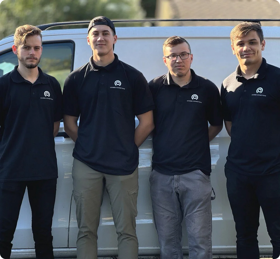 Covered Connections field team beside a company service vehicle